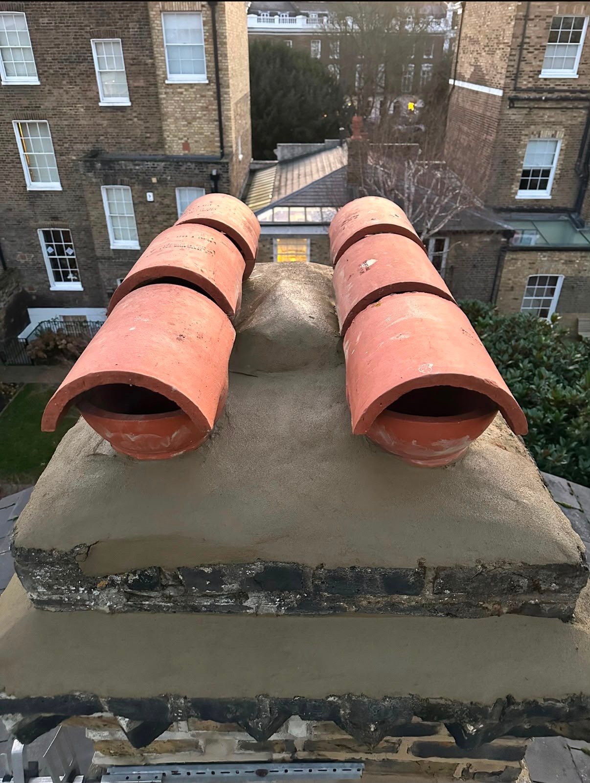 Close view of chimney brickwork and roof tiles